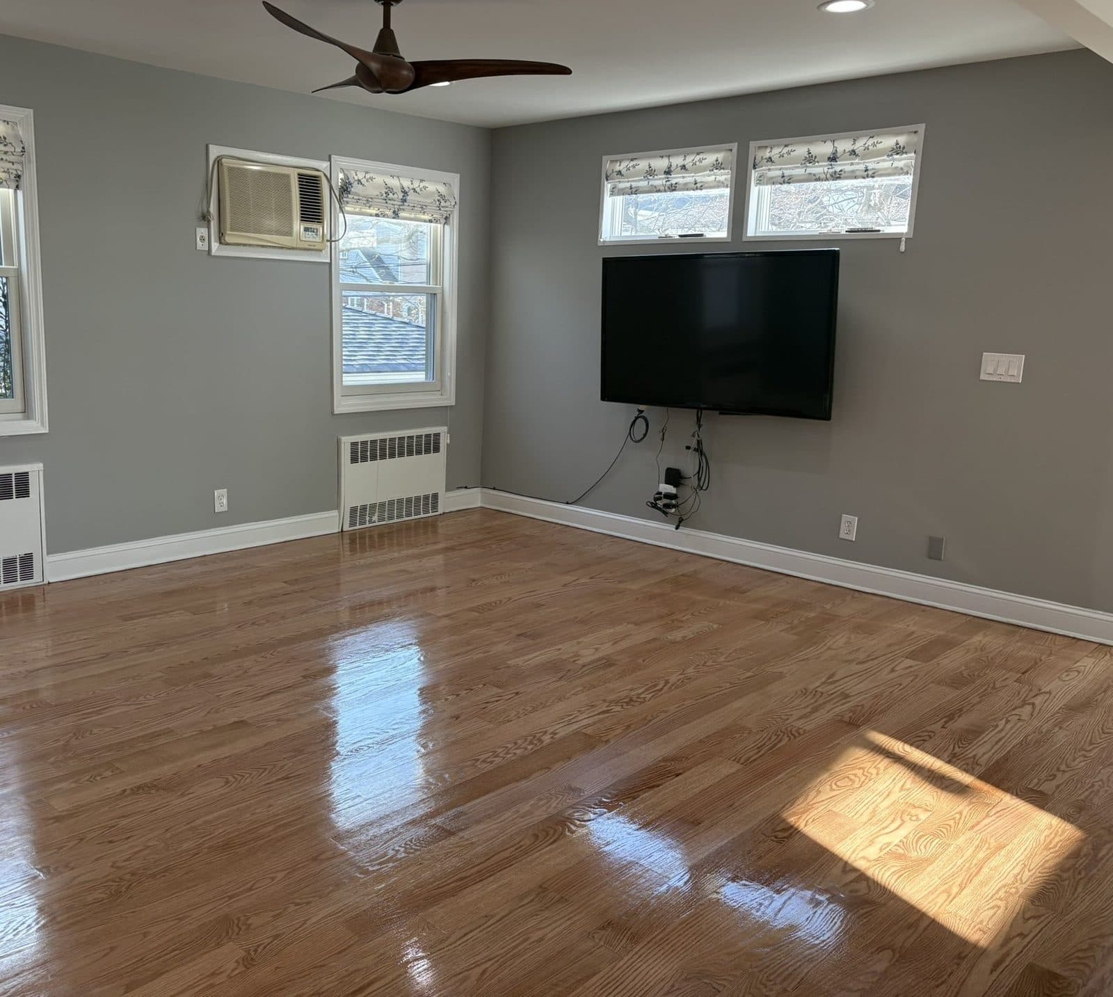 Refinished red oak hardwood floor in a Long Island living room